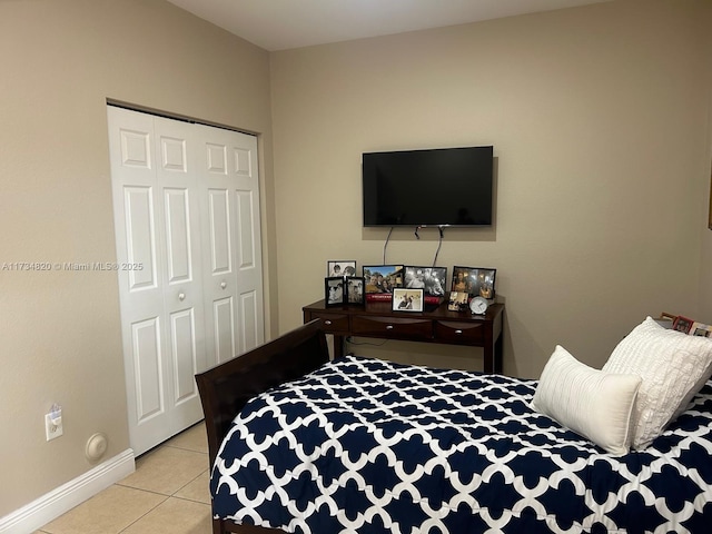 bedroom featuring a closet and light tile patterned floors