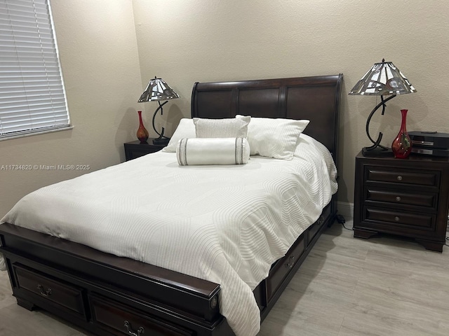 bedroom with light wood-type flooring