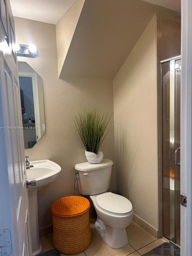 bathroom featuring an enclosed shower, tile patterned floors, and toilet