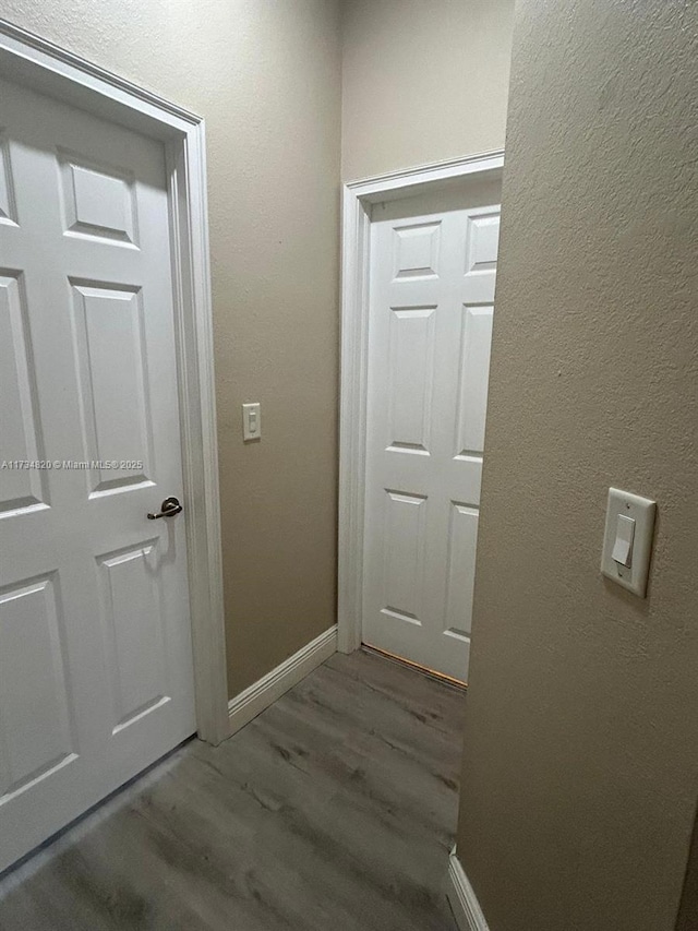 hallway with dark hardwood / wood-style floors