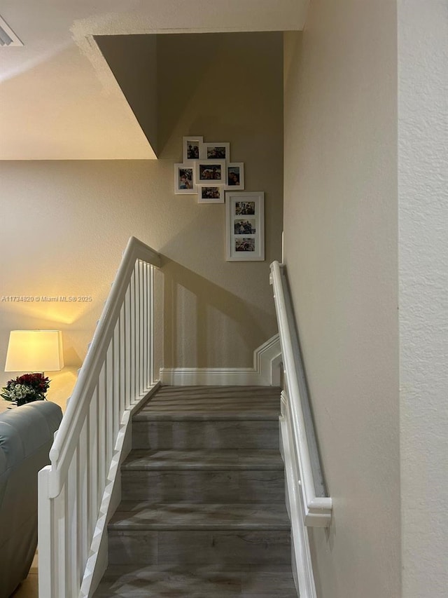 stairway with hardwood / wood-style flooring