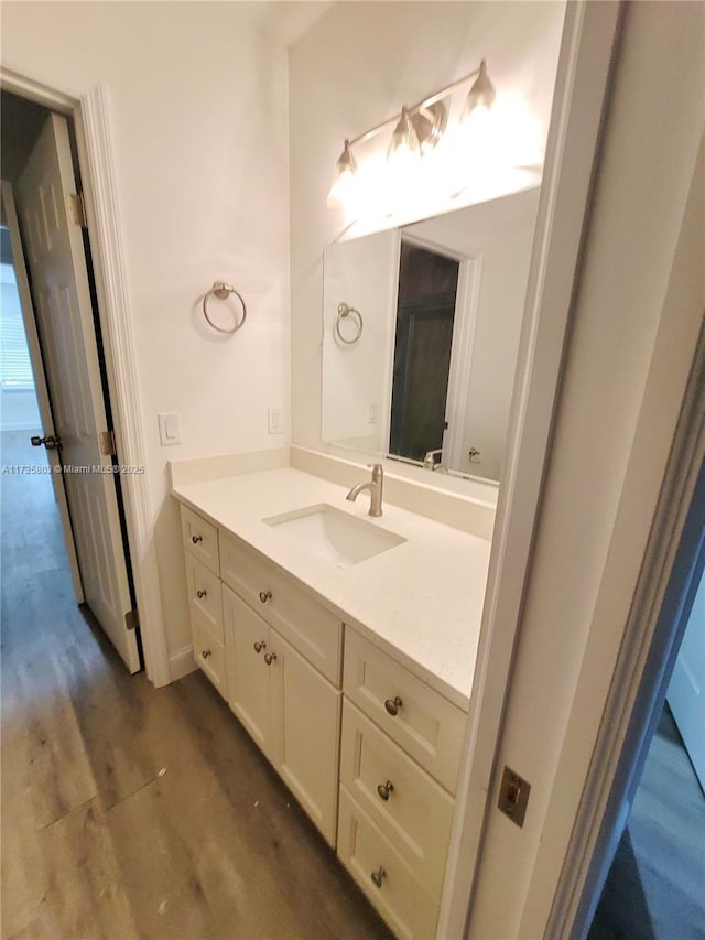 bathroom featuring wood finished floors and vanity