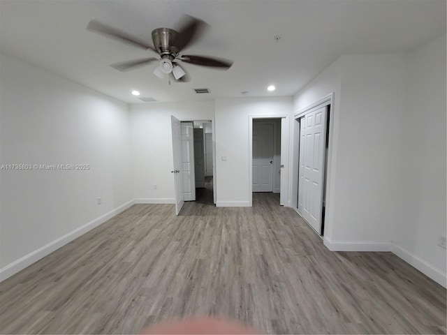 unfurnished bedroom featuring recessed lighting, light wood-type flooring, visible vents, and baseboards