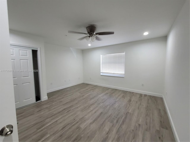 interior space featuring light wood-type flooring, ceiling fan, baseboards, and recessed lighting