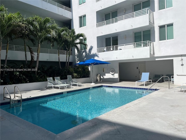 view of swimming pool with a patio area