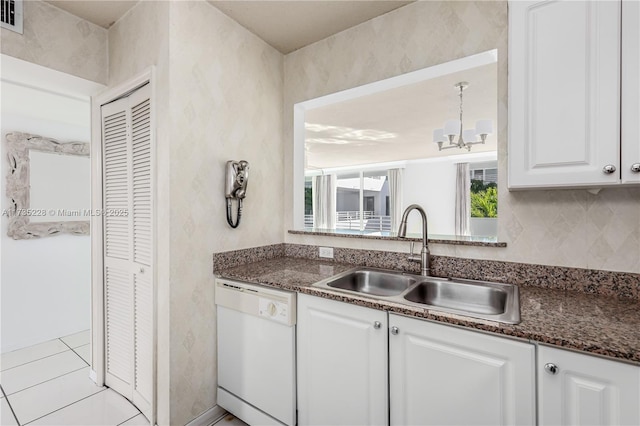 kitchen with sink, dishwasher, white cabinetry, tasteful backsplash, and dark stone counters