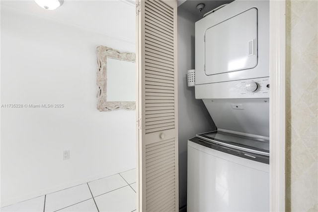 laundry room featuring stacked washer and clothes dryer and light tile patterned floors