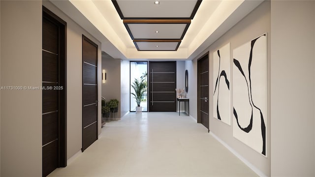 hallway with floor to ceiling windows and a raised ceiling