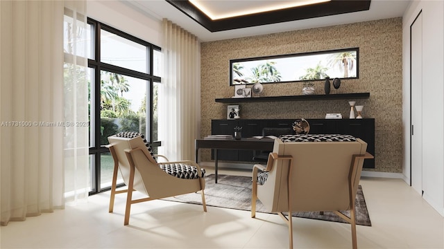 sitting room featuring baseboards, a tray ceiling, and wallpapered walls