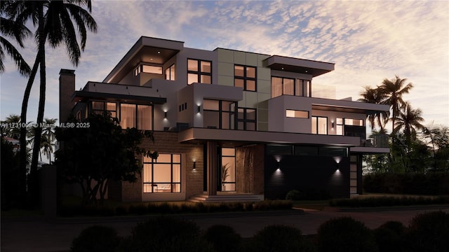 view of front of home with a chimney and stucco siding