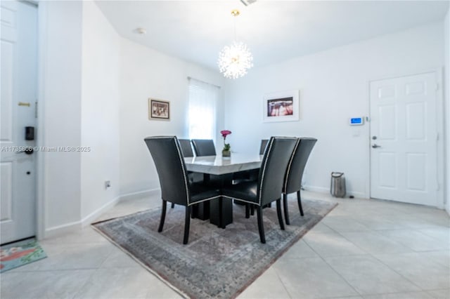 tiled dining room featuring a notable chandelier