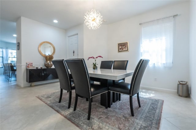 dining room featuring a notable chandelier and light tile patterned flooring