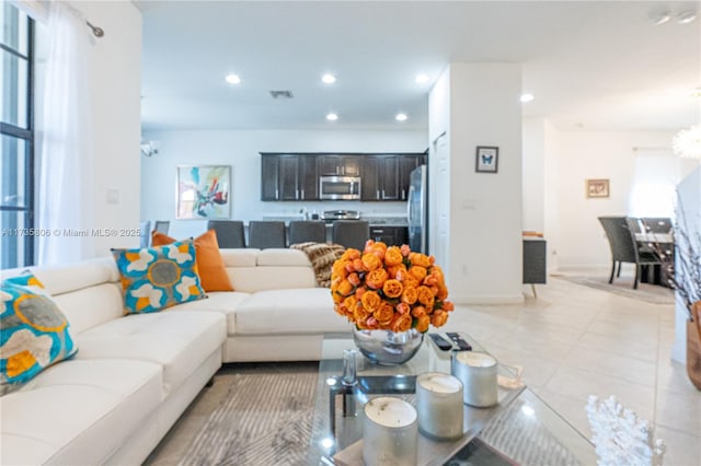 living room with an inviting chandelier and light tile patterned floors