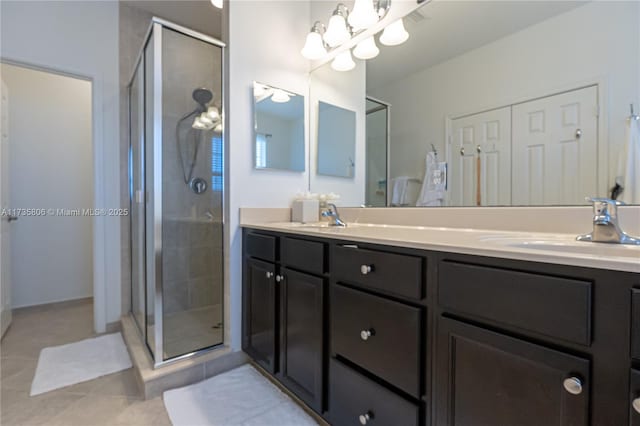 bathroom with walk in shower, vanity, and tile patterned flooring