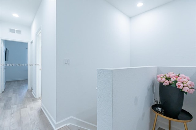 hallway with light hardwood / wood-style floors