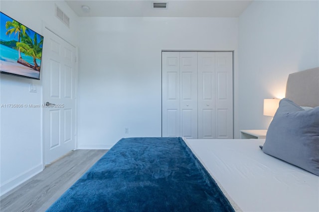 bedroom featuring hardwood / wood-style floors and a closet