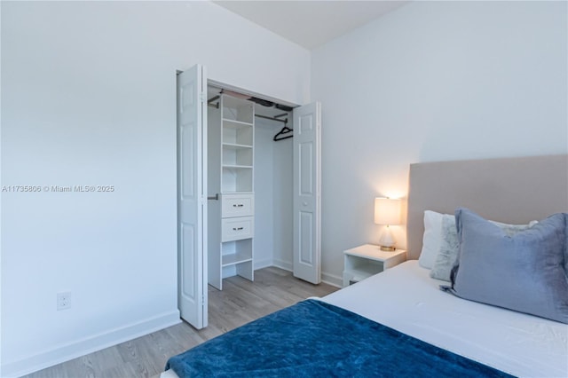 bedroom featuring light hardwood / wood-style floors and a closet