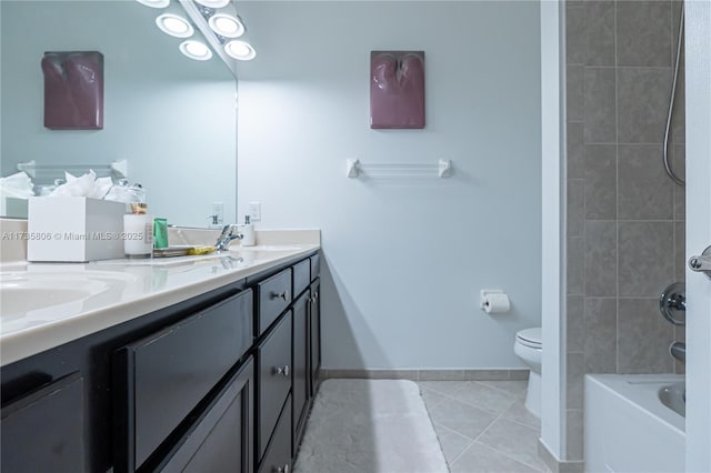 full bathroom featuring vanity, tiled shower / bath, tile patterned floors, and toilet