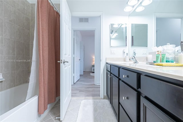 bathroom featuring shower / tub combo with curtain, vanity, and tile patterned flooring