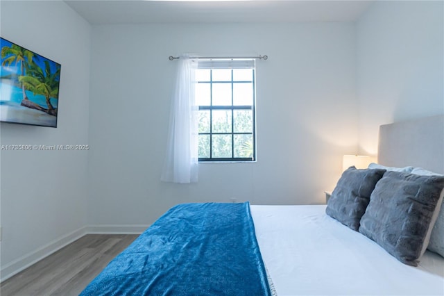 bedroom with hardwood / wood-style flooring