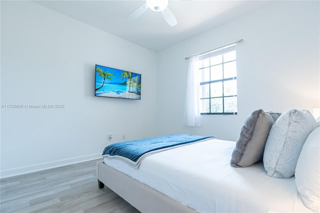 bedroom with ceiling fan and hardwood / wood-style floors