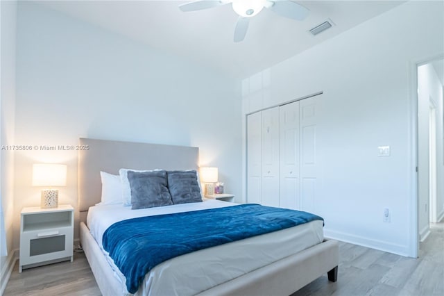 bedroom with ceiling fan, hardwood / wood-style floors, and a closet