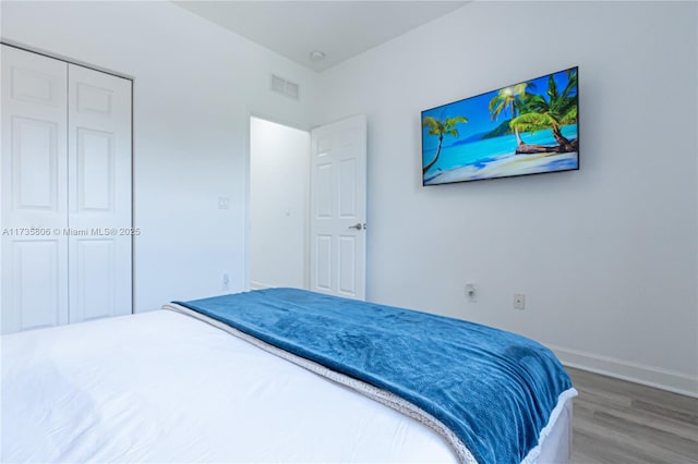 bedroom with hardwood / wood-style flooring and a closet