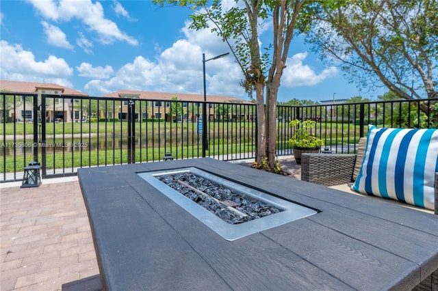 view of patio / terrace featuring an outdoor fire pit