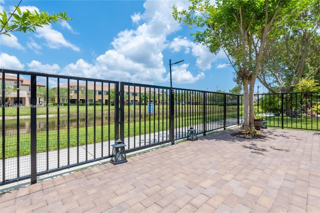 view of gate with a yard