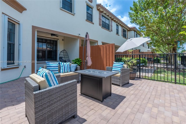 view of patio / terrace featuring an outdoor living space with a fire pit and ceiling fan