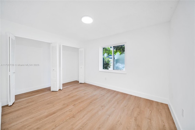 unfurnished bedroom with light wood-style floors and baseboards