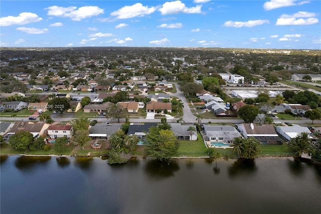 drone / aerial view featuring a residential view and a water view