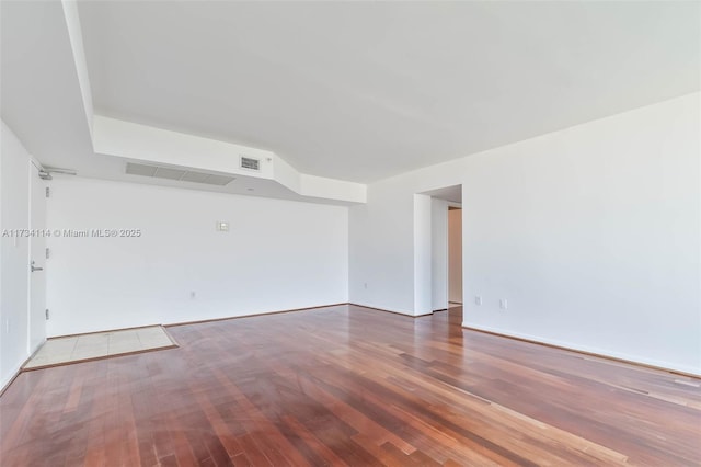 unfurnished room with wood-type flooring