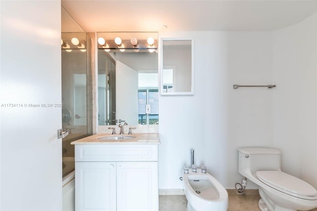 bathroom with a bidet, toilet, vanity, and walk in shower