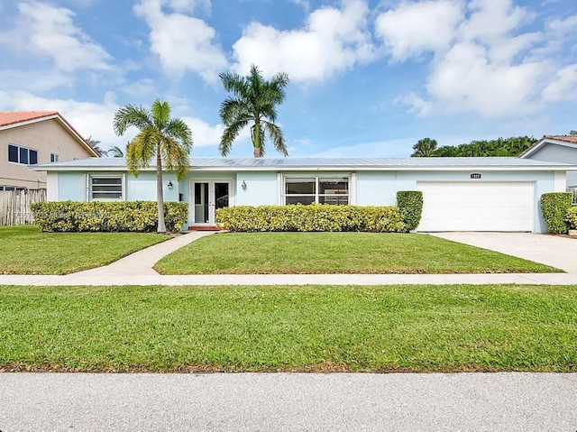 single story home featuring a garage and a front yard