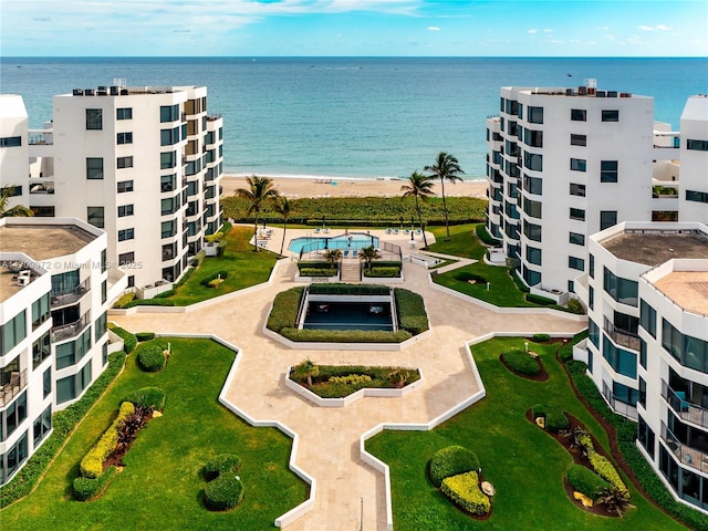 bird's eye view with a water view and a beach view