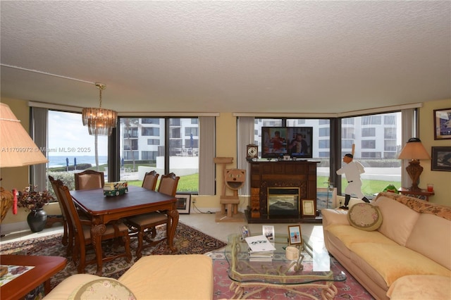 living room with a wall of windows, a chandelier, and a textured ceiling