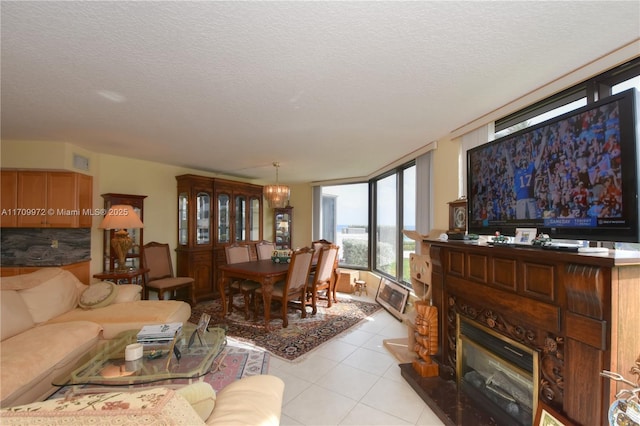 living room with floor to ceiling windows, light tile patterned flooring, a notable chandelier, and a textured ceiling