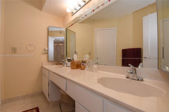 bathroom featuring vanity, tile patterned floors, and walk in shower