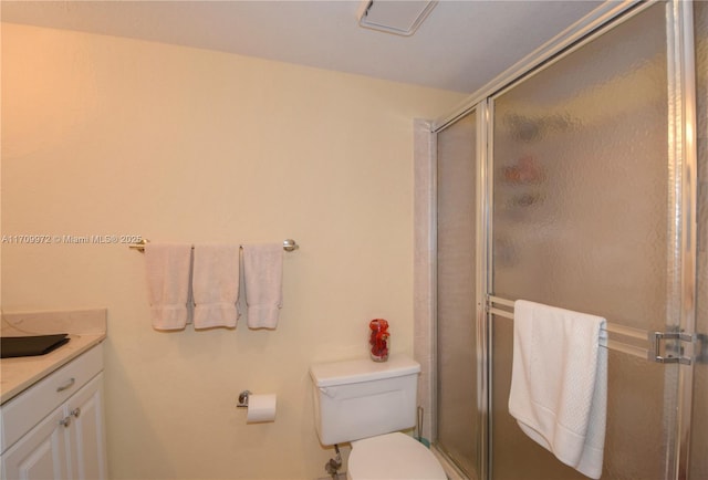 bathroom with vanity, toilet, and an enclosed shower