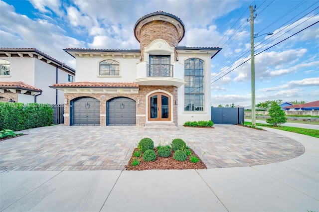 mediterranean / spanish house featuring a garage and french doors