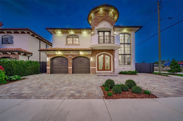 mediterranean / spanish-style house featuring a garage and french doors