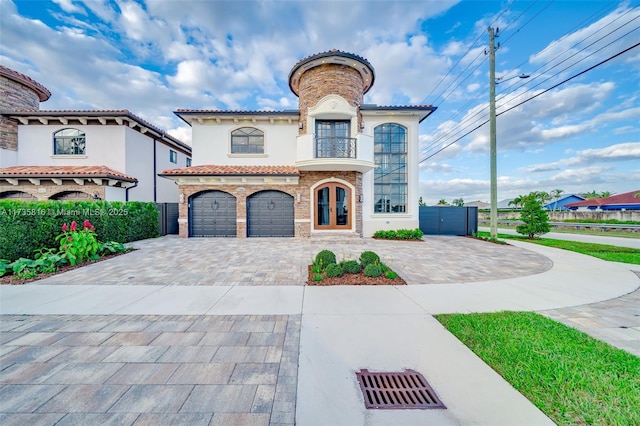 mediterranean / spanish-style house featuring french doors and a garage