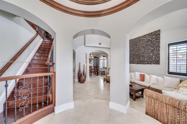 interior space with crown molding, plenty of natural light, and a high ceiling