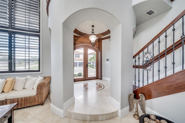 foyer entrance featuring a healthy amount of sunlight and french doors