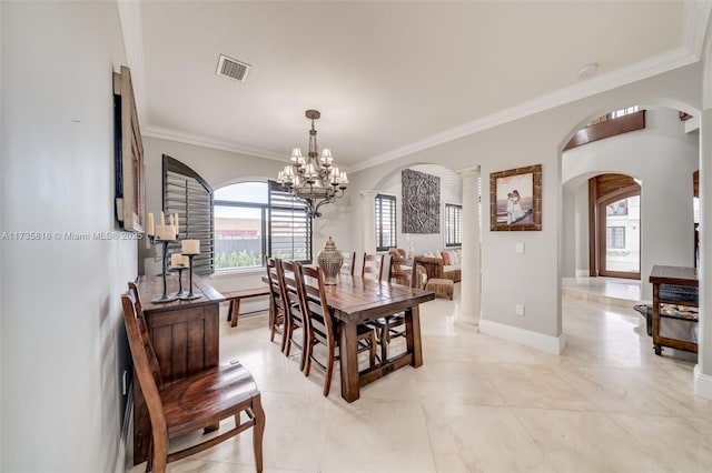 dining space with crown molding and a chandelier