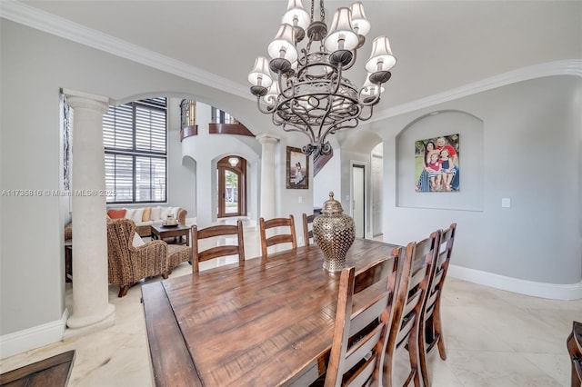 dining room featuring decorative columns, ornamental molding, and a notable chandelier