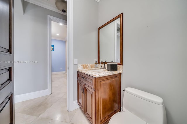 bathroom with crown molding, vanity, toilet, and tile patterned flooring