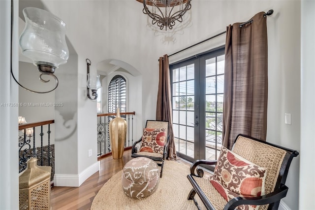 sitting room with light hardwood / wood-style flooring and french doors