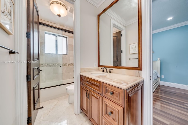 full bathroom featuring vanity, ornamental molding, toilet, and combined bath / shower with glass door